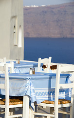 Image showing classic Greek island restaurant furniture with view of the volca