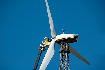 Image showing Man repairs windmill