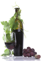 Image showing Glass red wine and bottle with grape´s leafs