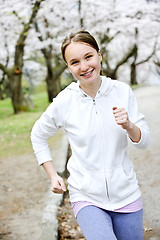 Image showing Girl jogging in park