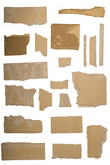 Image showing Pieces of torn brown corrugated cardboard, Isolated on White