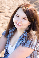 Image showing Portrait of a young smiling girl with brown hair