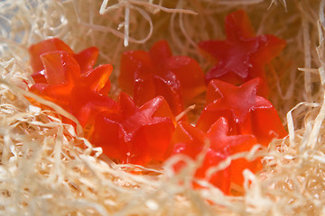 Image showing Red soap in the form of stars on a straw background