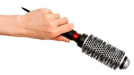 Image showing Hand with hairbrush