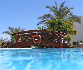 Image showing Bridge over the swimming pool with life buoy