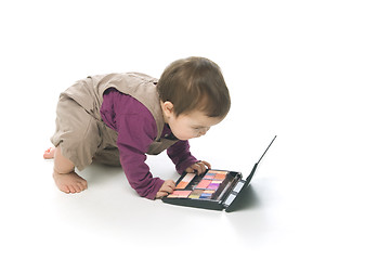 Image showing Baby girl with a cosmetic box