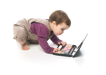 Image showing Baby girl with a cosmetic box