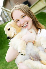 Image showing Girl with puppy