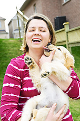 Image showing Woman holding puppy