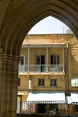 Image showing street scene of retail store through pillars arches of ancient s