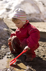 Image showing Toddler playing in the mud