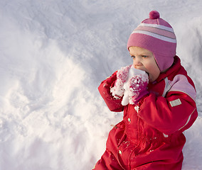 Image showing Toddler eating snow