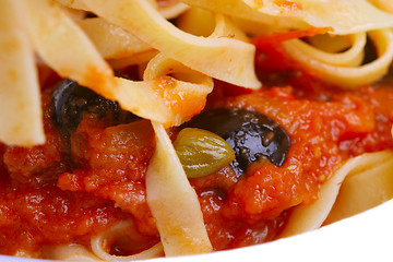 Image showing Pasta alla puttanesca with black olives, capers, anchovies and c