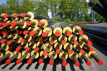 Image showing PVC pipes stacked in construction site    