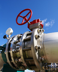 Image showing Industrial zone, Steel pipelines and valve on blue sky         