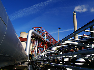 Image showing Industrial zone, Steel pipelines and smokestack on blue sky    