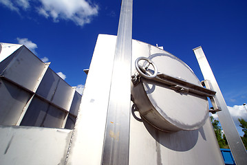 Image showing Industrial zone, Steel pipelines and valve on blue sky 