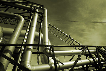 Image showing industrial pipelines on pipe-bridge against sky  