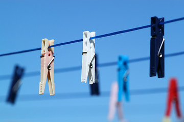 Image showing cloth pegs with a under the blue sky 