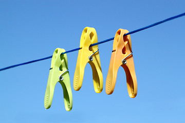 Image showing cloth pegs with a under the blue sky