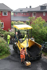 Image showing Workers spreading asphalt