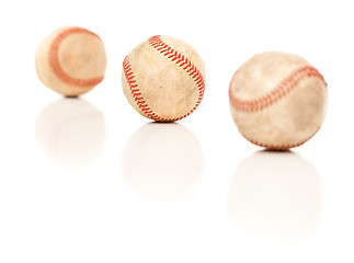 Image showing Three Baseballs Isolated on Reflective White