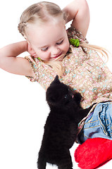 Image showing Little girl playing with kitten