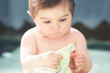 Image showing Cute baby playing with towel