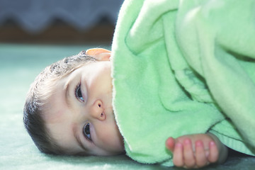 Image showing Serene baby on green floor