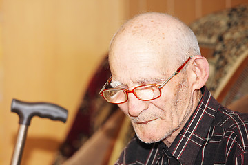 Image showing Pensive senior on sofa