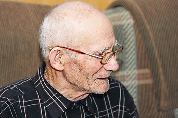 Image showing Senior on sofa sideview
