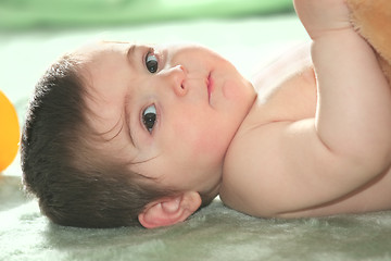 Image showing Baby laying down on floor