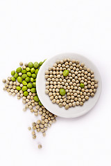 Image showing Fresh and dried green peas on plate