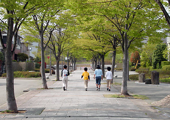 Image showing   Children group walking on a street-low size looks good.