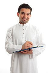 Image showing Smiling businessman writing in folder