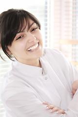 Image showing Smiling brunette in smock