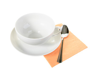 Image showing White empty mug and spoon on orange paper napkin