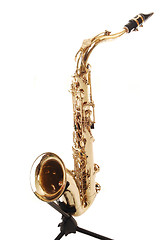 Image showing An brass saxophone on the stand.