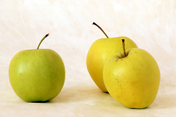 Image showing Three yellow apples on painted background