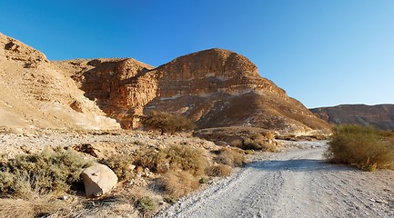 Image showing Desert landscape with mountains and road at sunset  