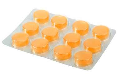 Image showing Orange pills in metallic blister