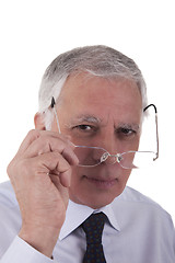 Image showing Portrait of a mature  businessman,putting the glasses