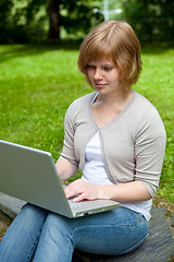 Image showing Young female with laptop