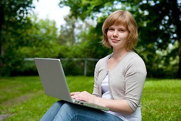 Image showing Young female with laptop