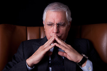 Image showing old businessman  seated on a chair, thinking