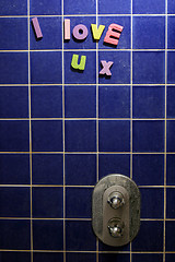 Image showing I Love You message written on shower using foam letters