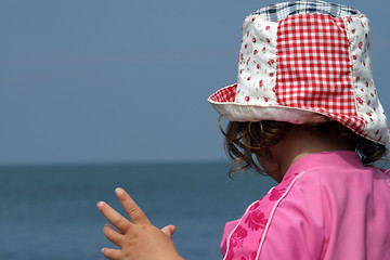 Image showing Young girl in sunhat on beach