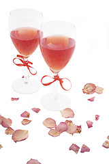 Image showing two red wine and rose petals