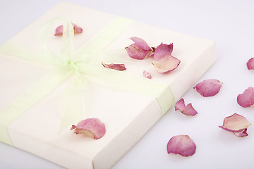 Image showing present box with rose petals