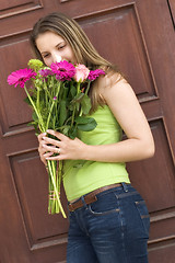 Image showing Girl Smelling Flowers
